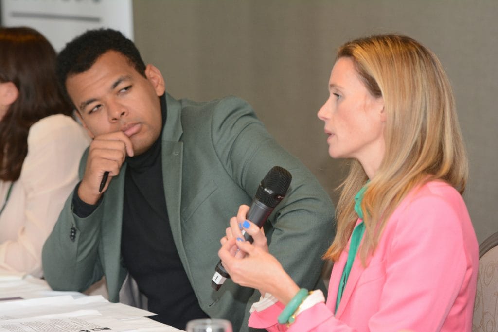 A picture of UK Music Chief Executive Jamie Njoku-Goodwin listening to Grace Meadowns, Campaign Director of Music for Dementia.