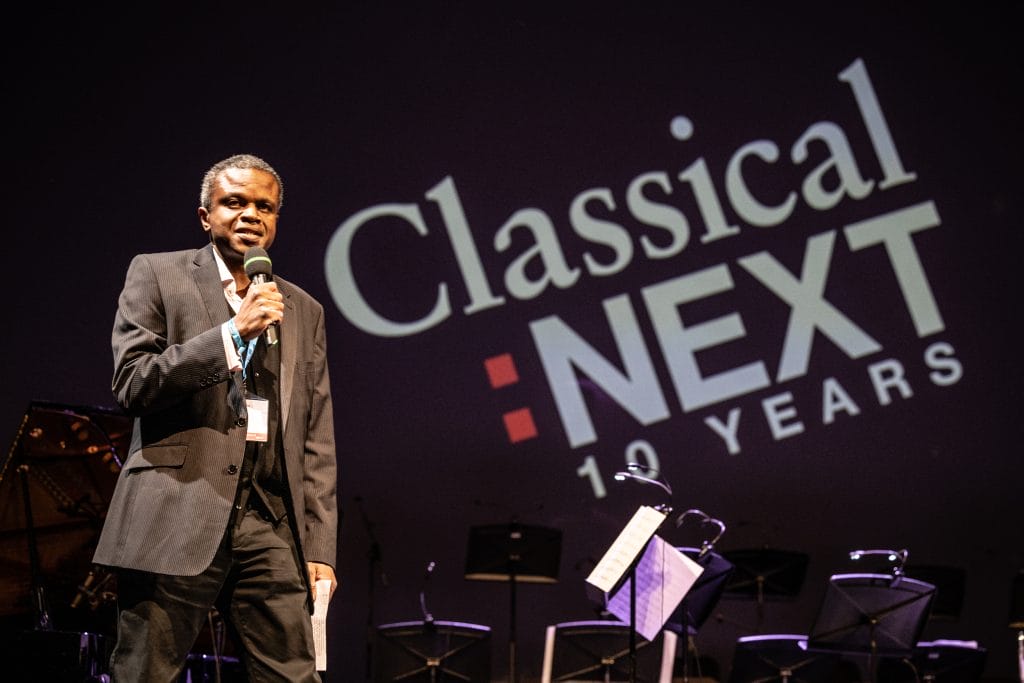 This is a pictures of a person introducing the Black Lives In Music performance at Classical: Next. 